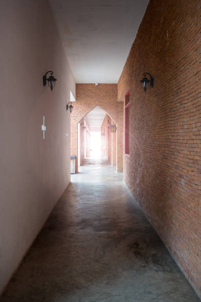 Light at the end of corridor. Ancient walk way made from red brick wall. Light at the end of corridor. Ancient walk way made from red brick outside hall. madieval stock pictures, royalty-free photos & images