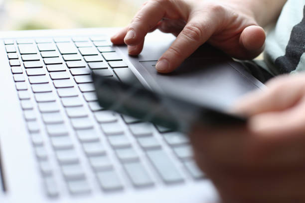 istock Male arms hold credit card press buttons 1060562602