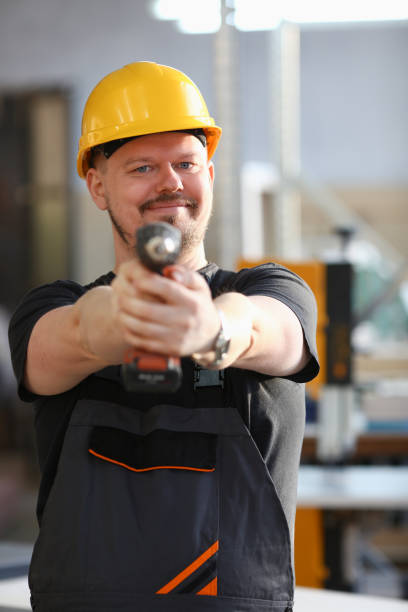 istock Arms of worker using electric drill closeup 1060565896