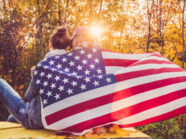 istock Happy married couple holding the US flag 1060568822