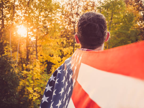 istock Attractive, stylish man holding a waving US Flag 1060569636