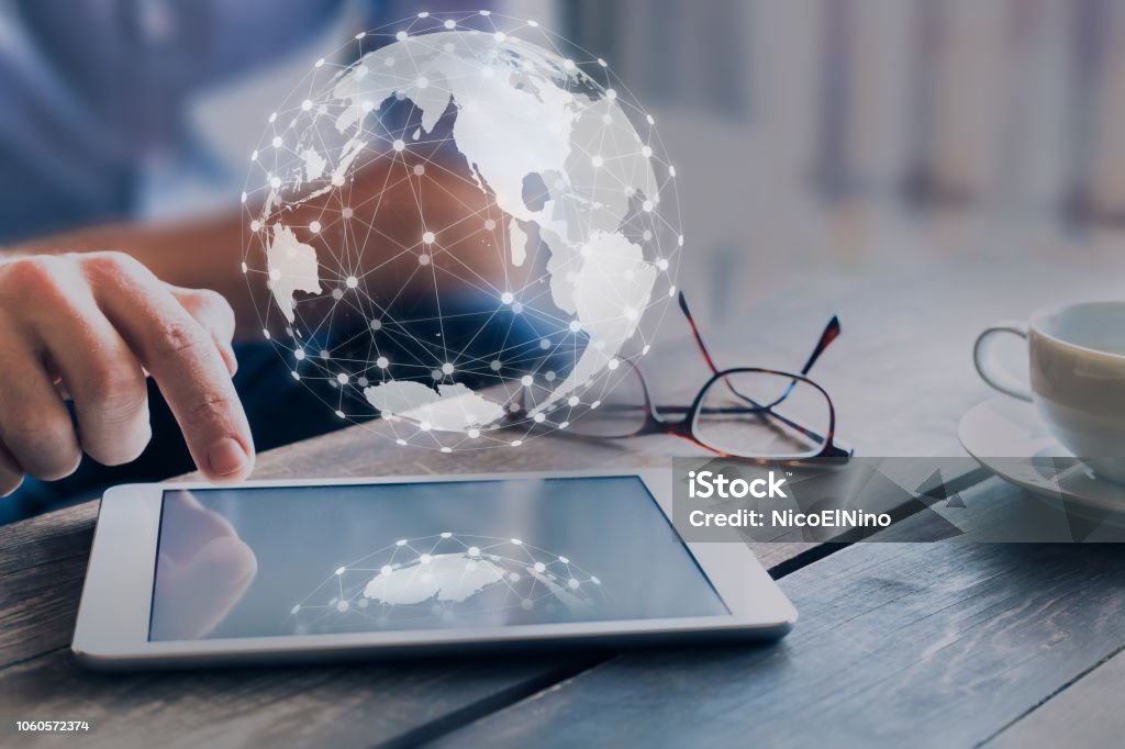 Global business network connection around digital globe, internet of things (IoT) concept, international communication,  worldwide finance technology (fintech), businessman using digital tablet Global Business Stock Photo