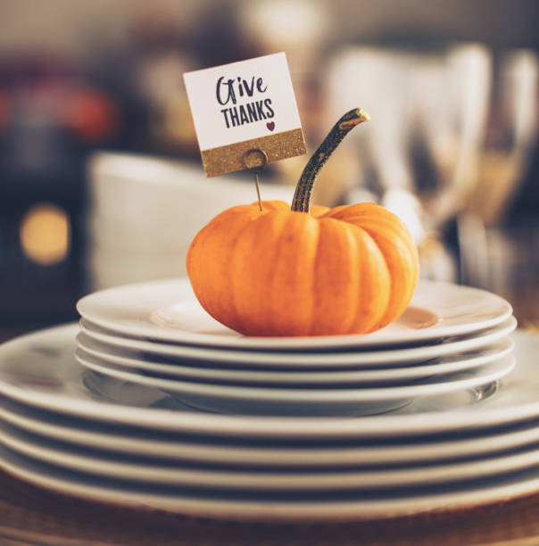 istock Thanksgiving table setting with pumpkin and gold colored details 1060575002