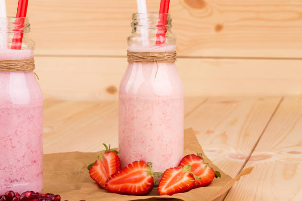 istock Two berry smoothie in a little milk bottles. 1060580396