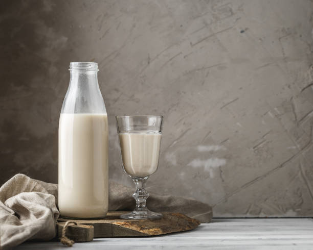 istock Fresh milk in glass bottle on rustic background 1060583348