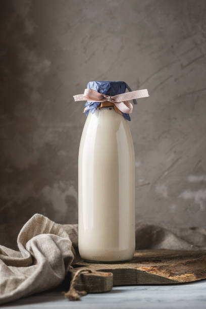 istock Fresh milk in glass bottle on rustic background 1060583358