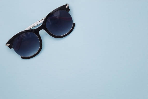 istock Women's sunglasses are on a blue background in the upper left corner. 1060585384