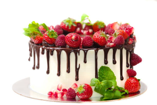 istock cake covered with berries of raspberry strawberry pomegranate mint leaves doused with chocolate on an isolated white background 1060586232
