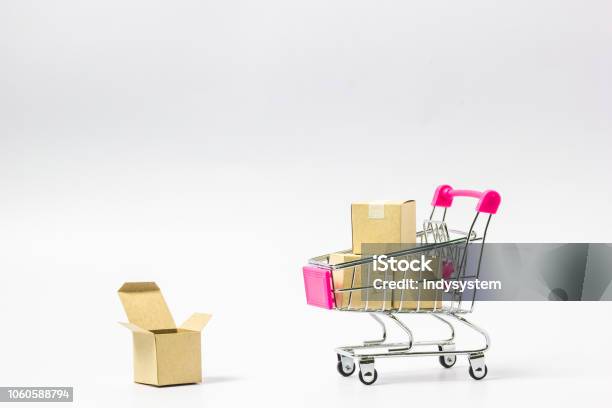 Shopping Cart With Paper Carton On White Background Stock Photo - Download Image Now