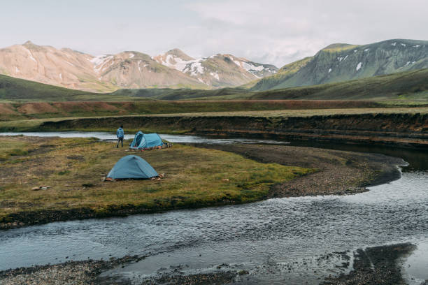 Yellow tent  near the river in Iceland Highlands
