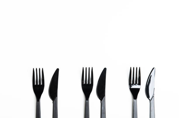 istock Clean plastic black forks and knives on white background. Disposable dishes, environmental pollution. Copy space, top view, flat lay. 1060591468