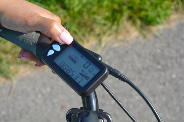istock Turning on electric bike, E-bike or bicycle. Pressing a button on control board or controller to choose speed and power level. Display showing, speed, power level and distance in kilometres. 1060591554