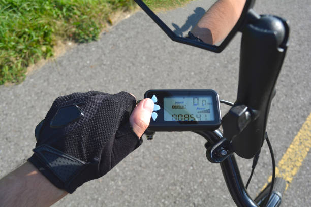 istock Turning on electric bike, E-bike or bicycle. Pressing a button on control board or controller to choose speed and power level. Display showing, speed, power level and distance in kilometres. 1060591602
