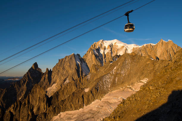 Mont Blanc , mont Maudit, mont blanc du Tacul , mountain range at Sunrise with the cableway of skyway Mont Blanc , mont Maudit, mont blanc du Tacul , mountain range at Sunrise with the cableway of skyway dent du geant stock pictures, royalty-free photos & images