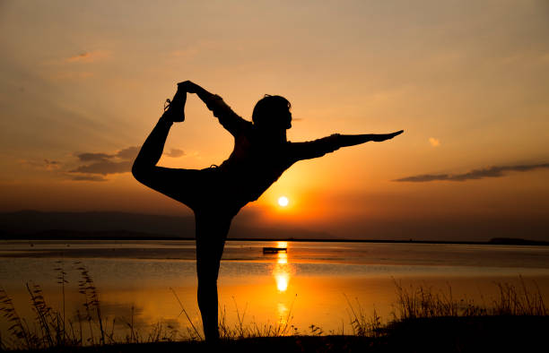 istock Silhouette woman standing on one leg. 1060592734