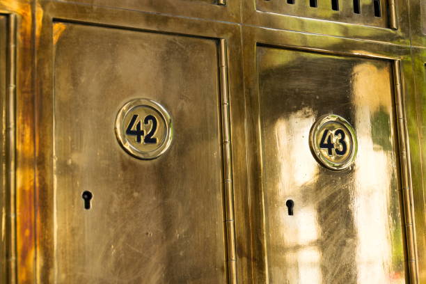istock Closed golden post office boxes with numbers in circles, banking security service concept, safety deposit boxes, p.o. box 1060599848