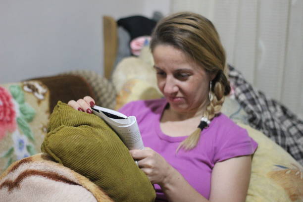 istock Woman reading book in bed 1060600334