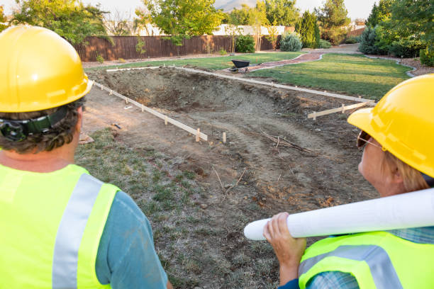 istock Male and Female Workers Overlooking Pool Construction Site 1060604248