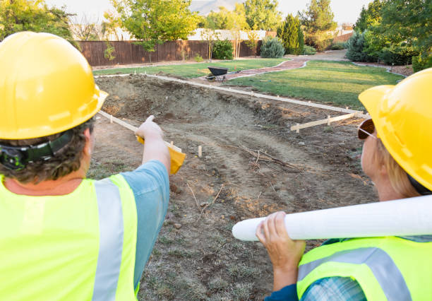 istock Male and Female Workers Overlooking Pool Construction Site 1060604260