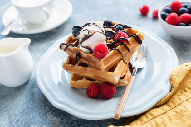 istock Tasty belgian waffles with vanilla ice cream and berries 1060610478