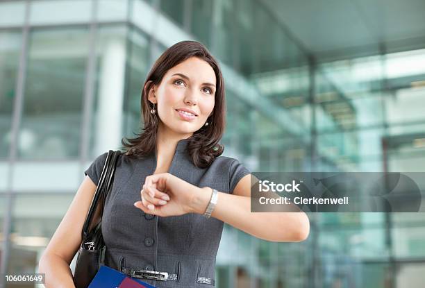 Businesswoman Looking At Watch In Airport Stock Photo - Download Image Now - Anticipation, Happiness, Urgency