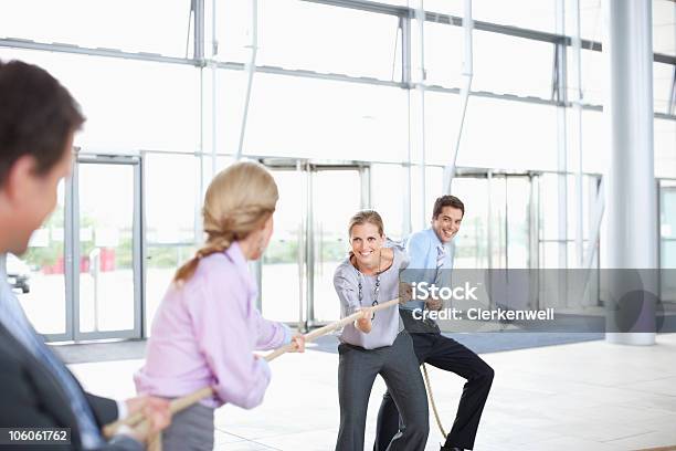 Business Colleagues Playing A Game Of Tug Of War Stock Photo - Download Image Now - 25-29 Years, 30-34 Years, 40-44 Years
