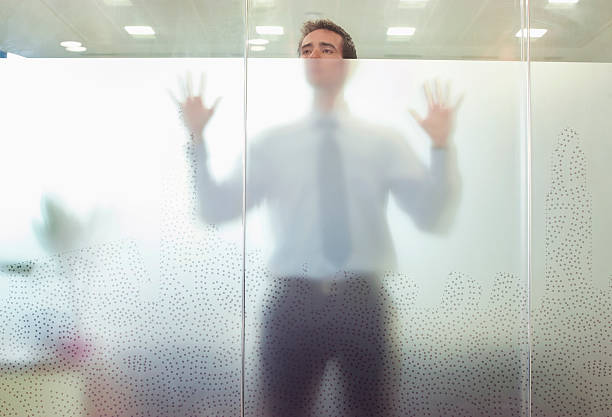 Business executive standing behind glass door  translucent stock pictures, royalty-free photos & images