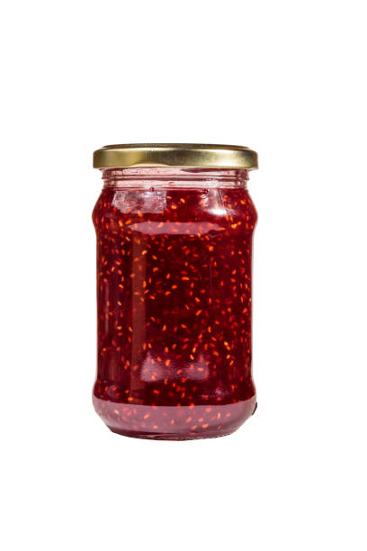 istock Raspberry jam in glass jar isolated on white background 1060621680