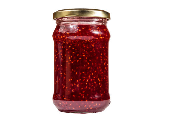 istock Raspberry jam in glass jar isolated on white background 1060621690