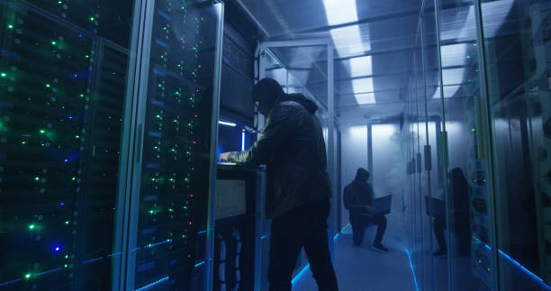 istock Two hackers finishing hack and escaping a smoke-filled room 1060626532