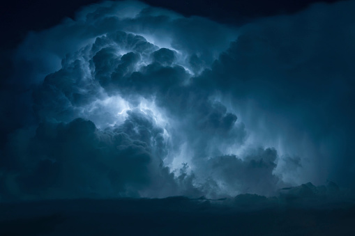 Blue Lightning strike surrounded by storm clouds