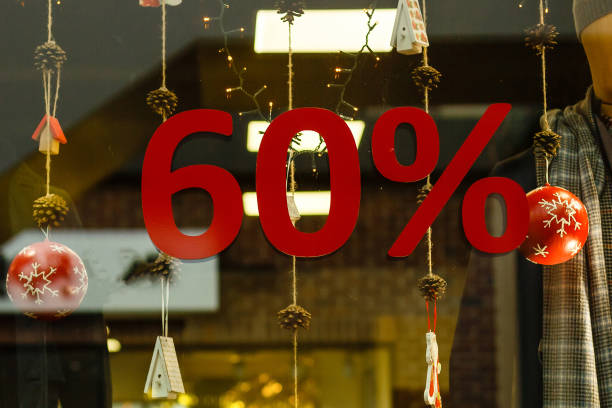 Shop-window information about sixty percent Christmas discounts Shop-window information about sixty percent Christmas discounts travel refund stock pictures, royalty-free photos & images