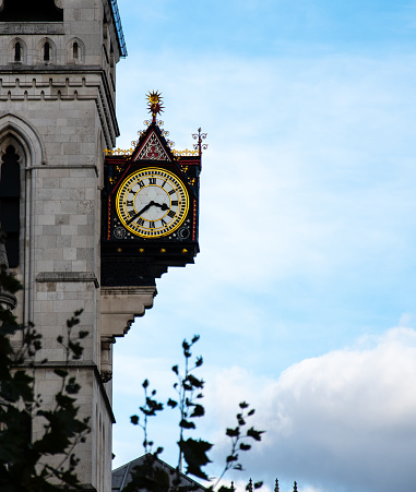 A clock hanging from the side of The Old Bailey high court building on Fleet Street