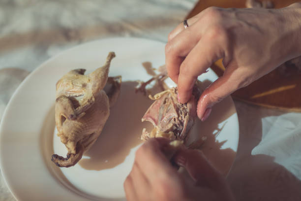 istock Woman is eating a cooked quail at the kitchen 1060633538