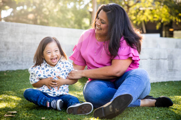 istock Young Mexican Mom Playing with Down's Syndrome Son in Park 1060636814