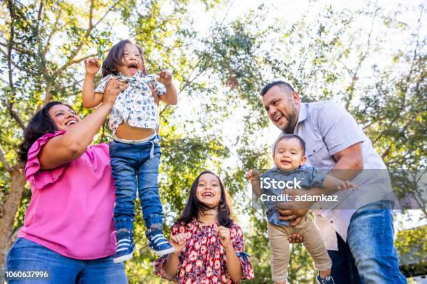 Mexican Family Playing In The Park Stock Photo - Download Image Now - Family, Overweight, Child