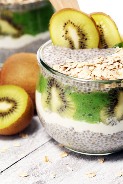 istock Healthy breakfast. chia pudding with kiwi and granola in glass on rustic background. 1060638010