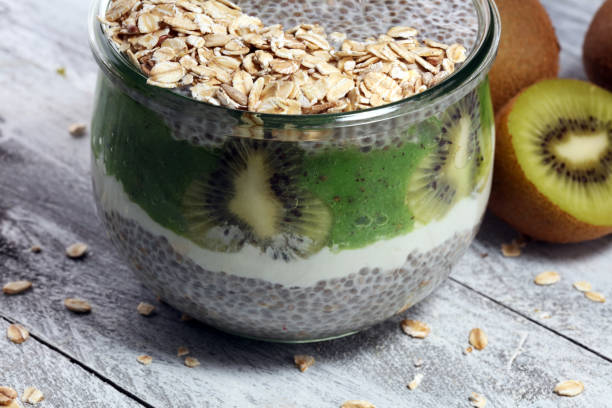 istock Healthy breakfast. chia pudding with kiwi and granola in glass on rustic background. 1060638074