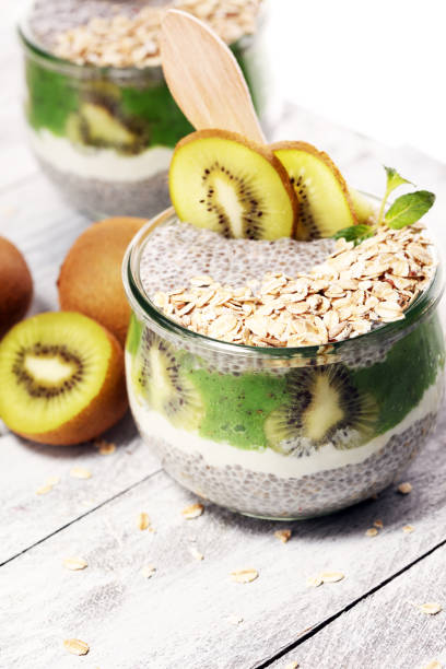 istock Healthy breakfast. chia pudding with kiwi and granola in glass on rustic background. 1060641010