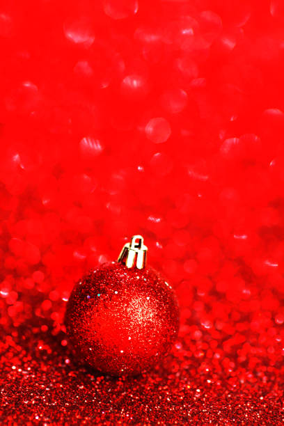 istock Beautiful red christmas ball on abstract glitter background close-up 1060642672