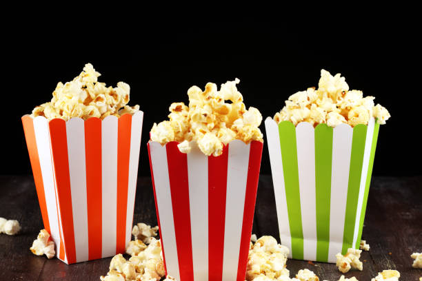 istock Cinema concept with popcorn in green white bag. 1060643216