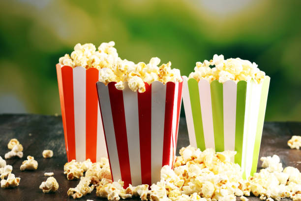 istock Cinema concept with popcorn in green white bag. 1060643278