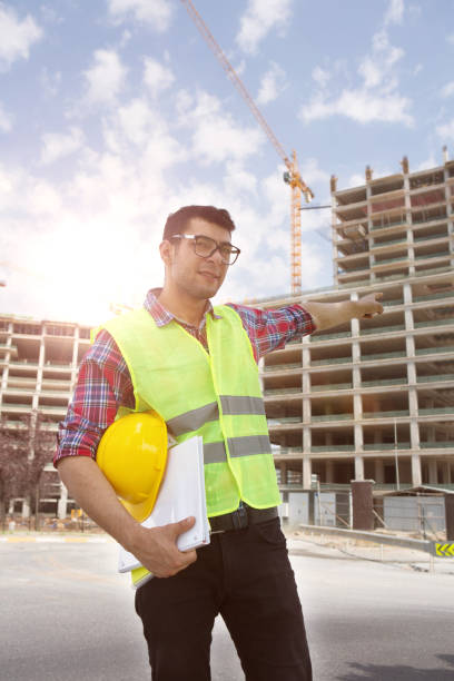 istock Young Engineer portrait with construction site and crane background. 1060644604