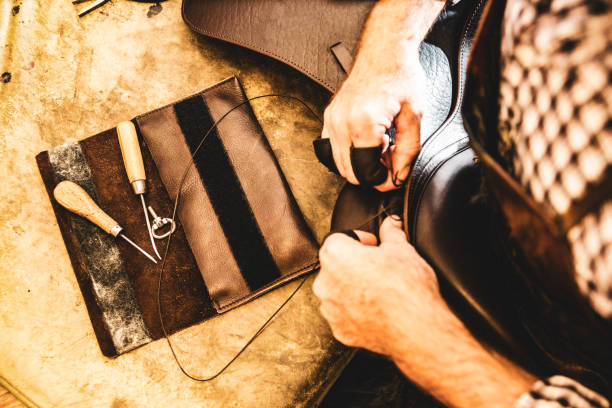 istock A saddle maker making a custom made saddle.  Real person, real life. 1060646420