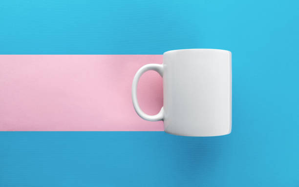 istock White mug on blue and pink background 1060648926