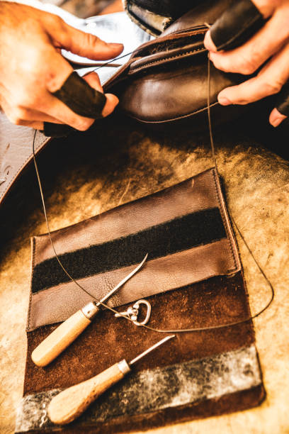 istock A saddle maker making a custom made saddle.  Real person, real life. 1060650440