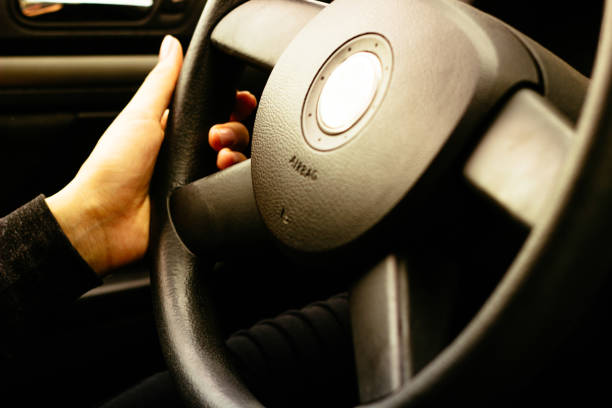 istock Female hand on steering wheel 1060650990