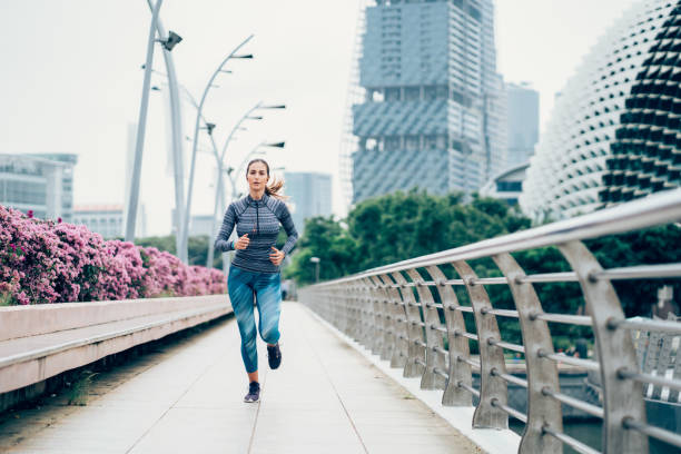 istock Sportswoman running on bridge 1060653026