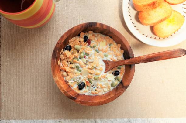 Healthy breakfast, muesli (granola), coffee salad and bread with wood plate