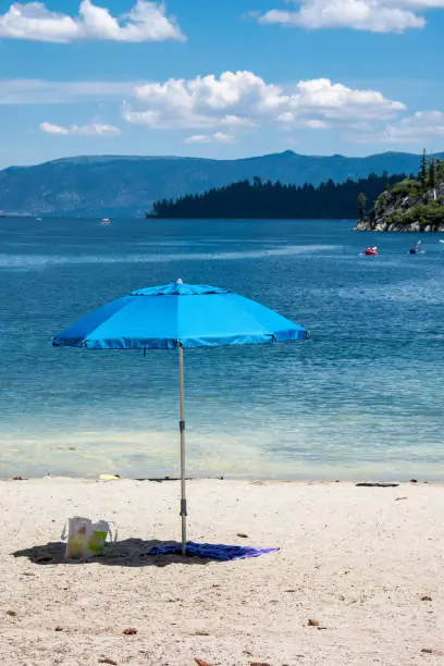 Umbrella on a sandy beach in South Lake Tahoe, California in Emerald Bay.